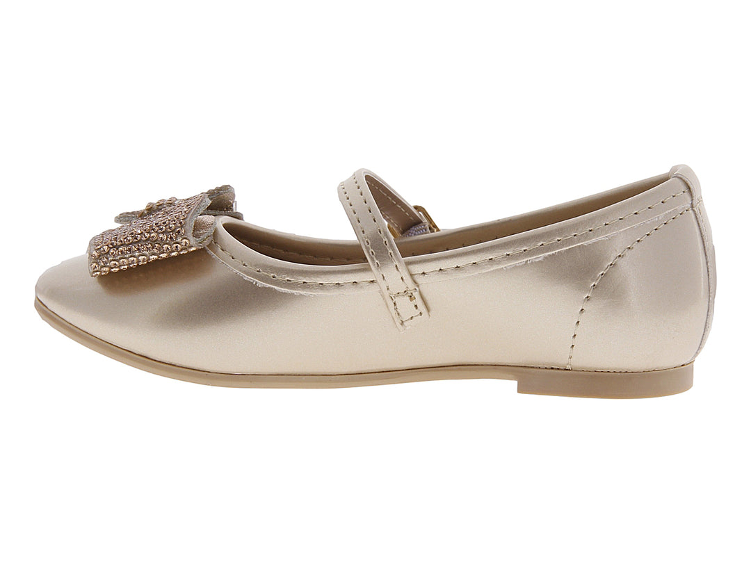 Zapato plano color oro para niña con moño decorado con brillantes y correa ajustable.