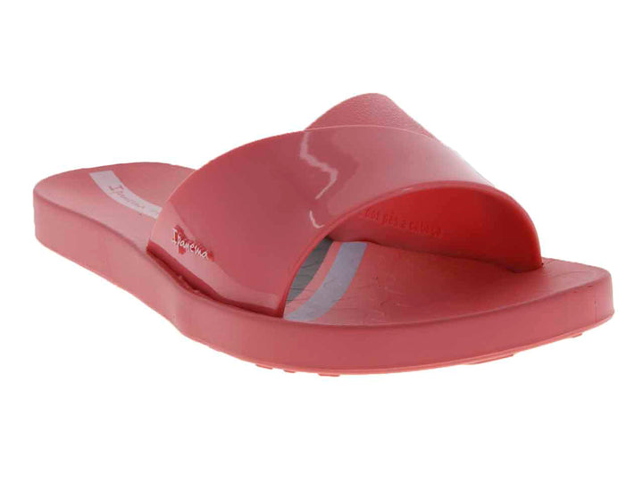 Sandalias slide de color rosa brillante con suela cómoda.