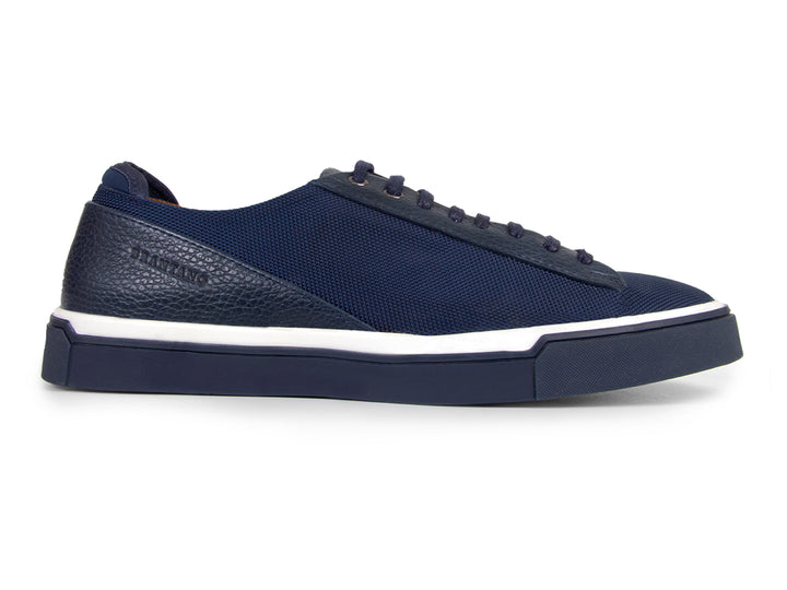 Tenis casuales color marino para hombre con suela blanca y detalles en tela y sintético.