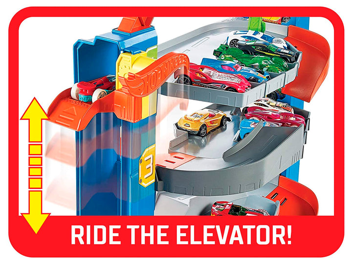 Set de juego Hot Wheels Stunt Garage con pista multinivel, rampas naranjas y un auto incluido en empaque original.