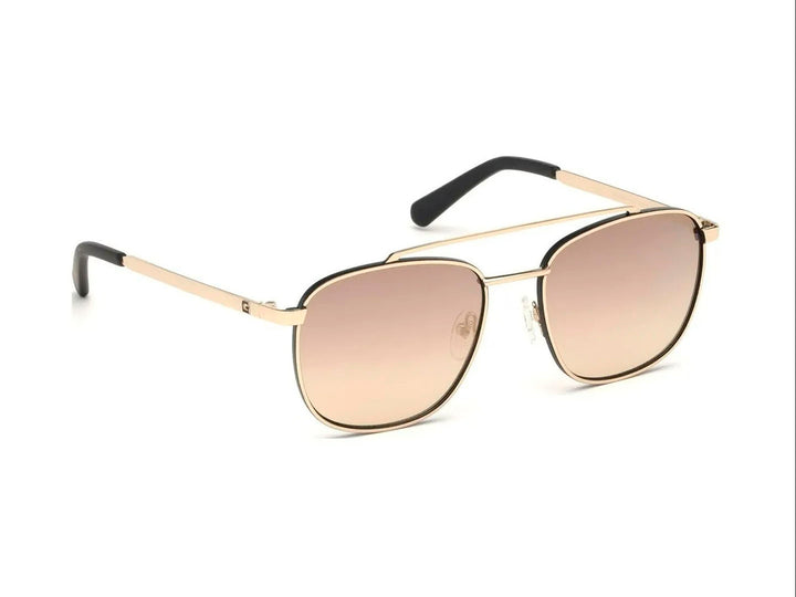 Lentes de sol estilo aviador GUESS con armazón dorado y cristales marrón degradado.