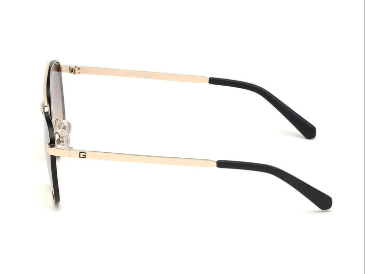 Lentes de sol estilo aviador GUESS con armazón dorado y cristales marrón degradado.