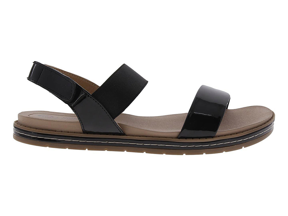 Sandalias negras de charol para mujer con suela marrón y correas cruzadas.