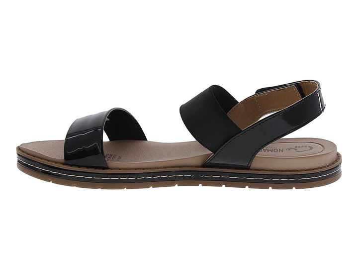 Sandalias negras de charol para mujer con suela marrón y correas cruzadas.