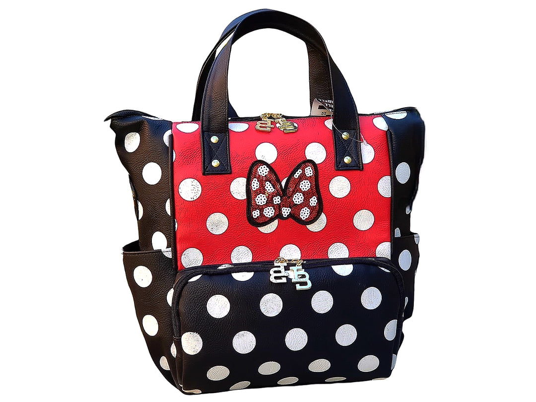Bolso mochila IBELL de color negro y rojo con estampado de lunares blancos y un moño decorativo al frente.
