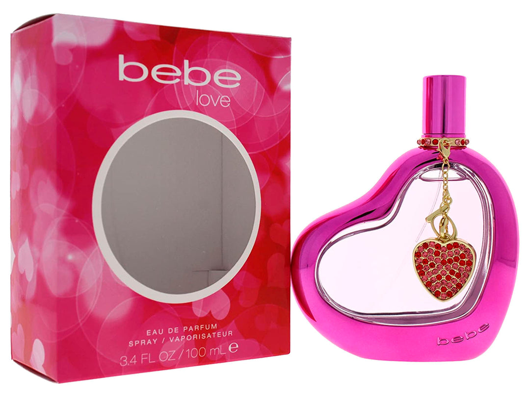 Perfume Bebe Love en botella y caja de color rosa con forma de corazón y dije decorativo.