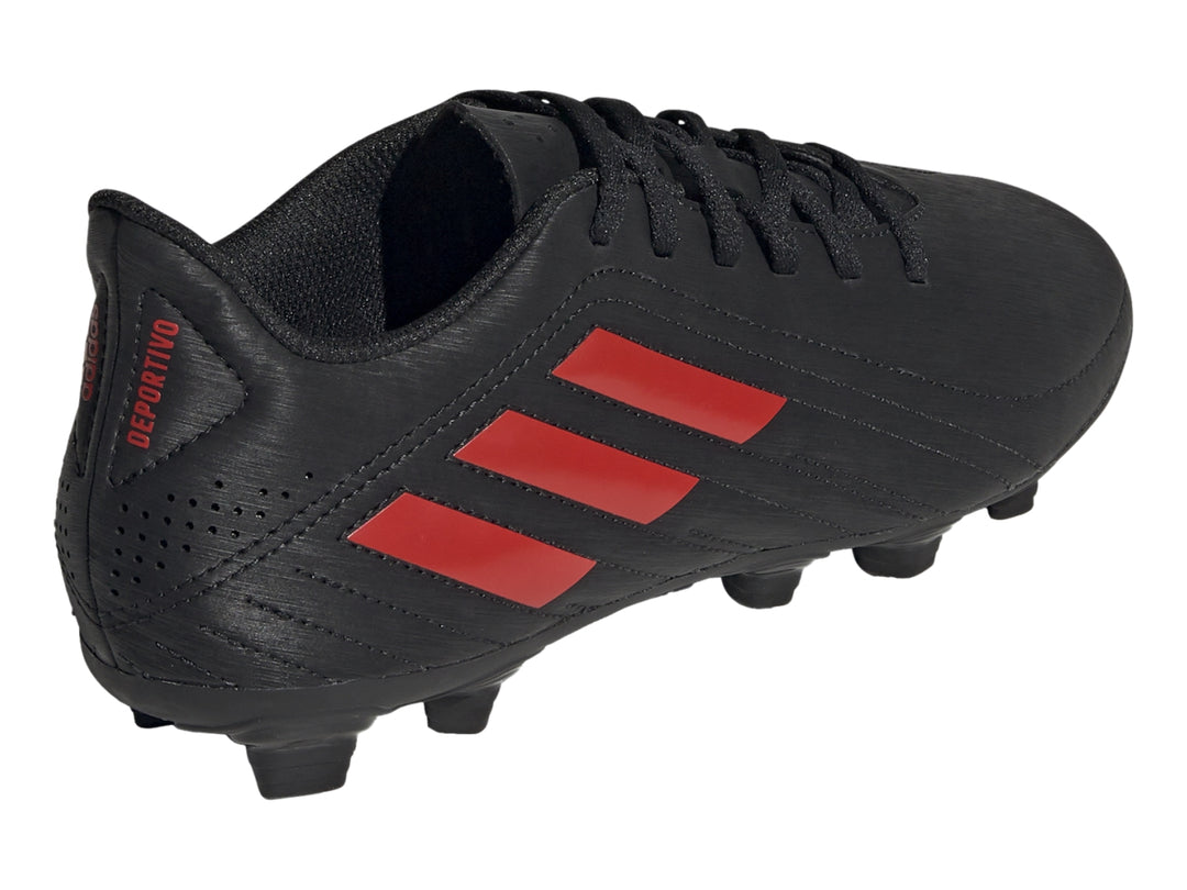 Zapato de fútbol Adidas color negro con tres franjas rojas y suela de tacos.