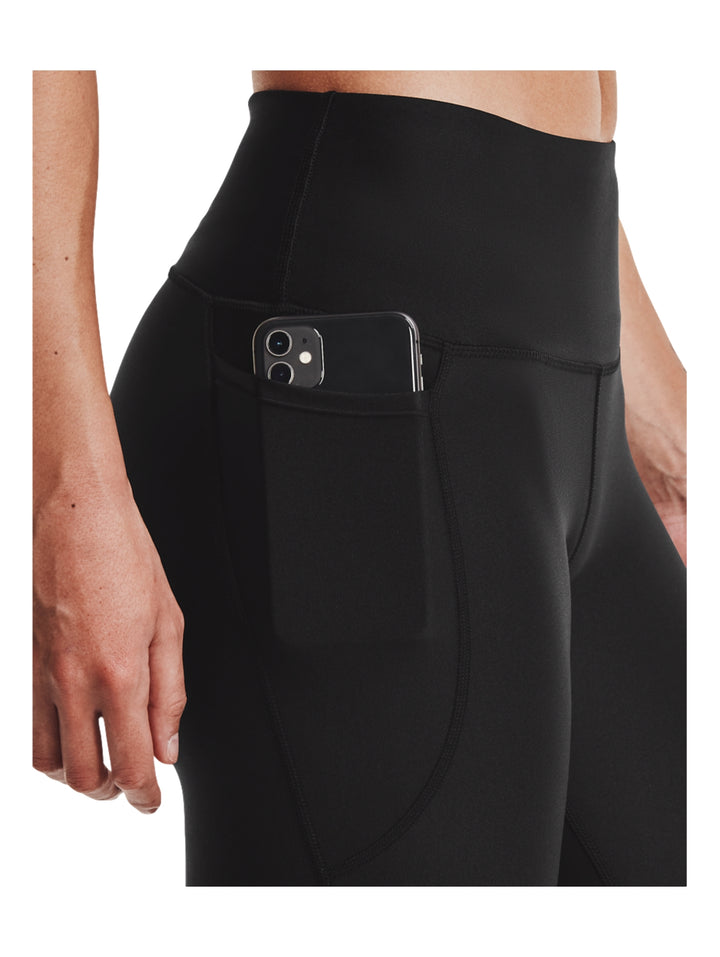 Mallas deportivas negras Under Armour para mujer con corte al tobillo.