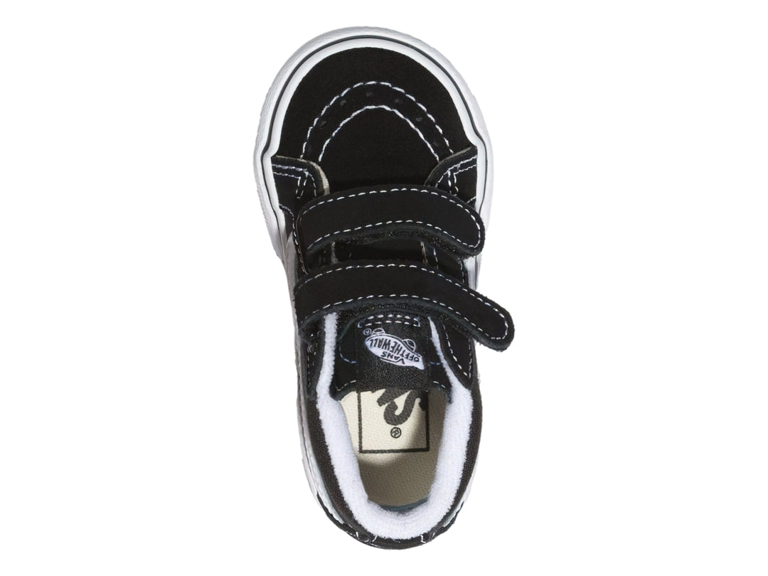 Tenis Vans Sk8 Mid Reissue color negro con suela blanca y cierres de velcro.