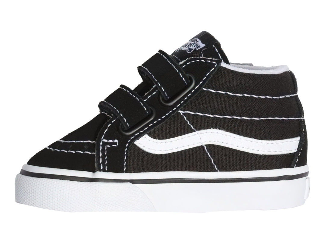 Tenis Vans Sk8 Mid Reissue color negro con suela blanca y cierres de velcro.