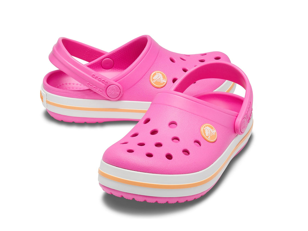 Zuecos Crocs Crocband para niño o niña en color rosa eléctrico con franja naranja en la suela.