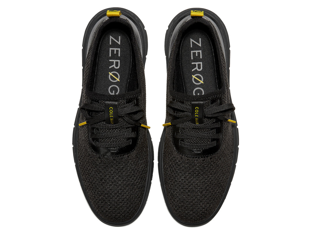 Tenis negros Cole Haan Generation Zerogrand Stitchlite para hombre con detalles amarillos.