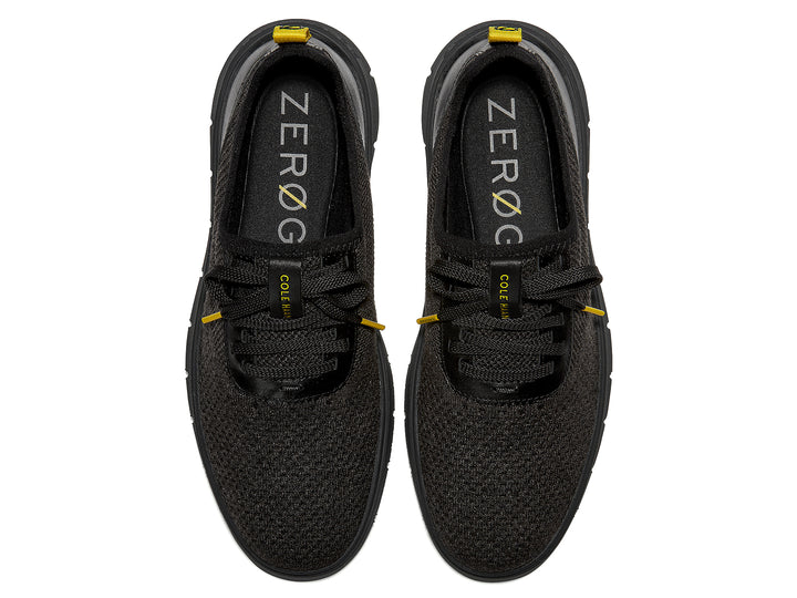 Tenis negros Cole Haan Generation Zerogrand Stitchlite para hombre con detalles amarillos.
