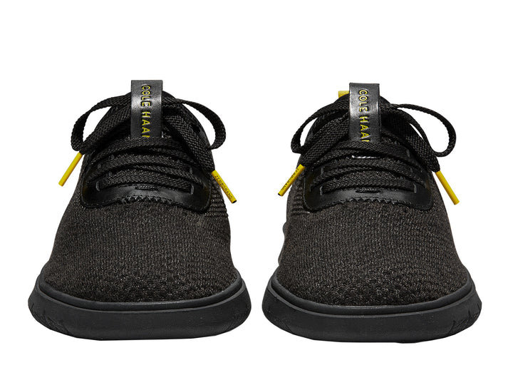 Tenis negros Cole Haan Generation Zerogrand Stitchlite para hombre con detalles amarillos.
