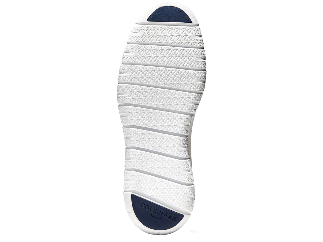 Tenis deportivos Cole Haan color azul marino con suela blanca y detalles en amarillo.