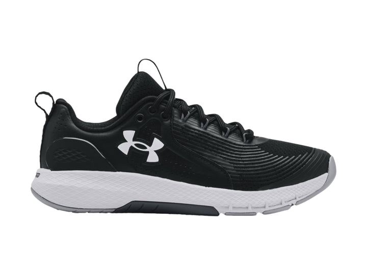 Tenis deportivos Under Armour Charged Commit TR 3 en color negro con suela blanca y logo lateral blanco.