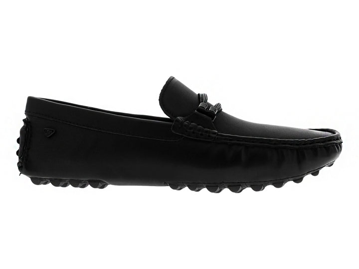 Zapato tipo mocasín color negro con suela texturizada y detalle decorativo en la parte superior.