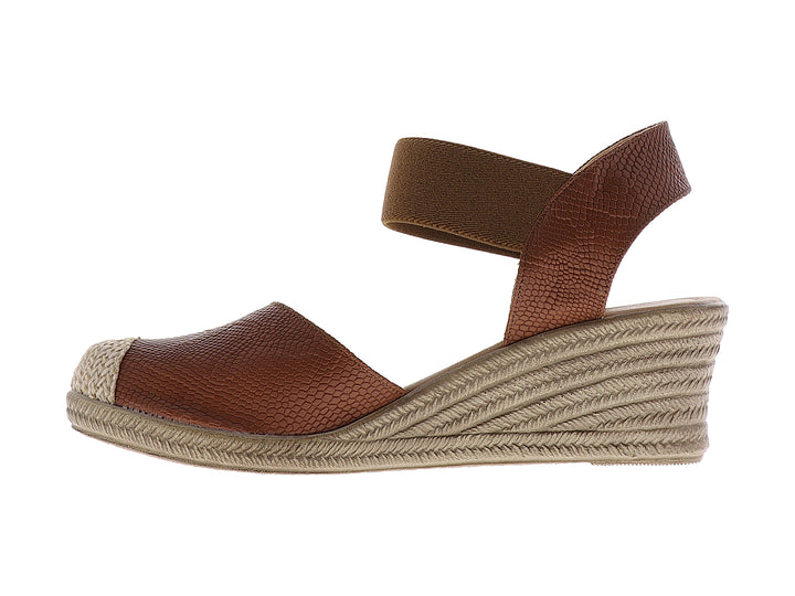 Sandalia de cuña color tan con textura de piel de serpiente y plataforma beige para mujer.