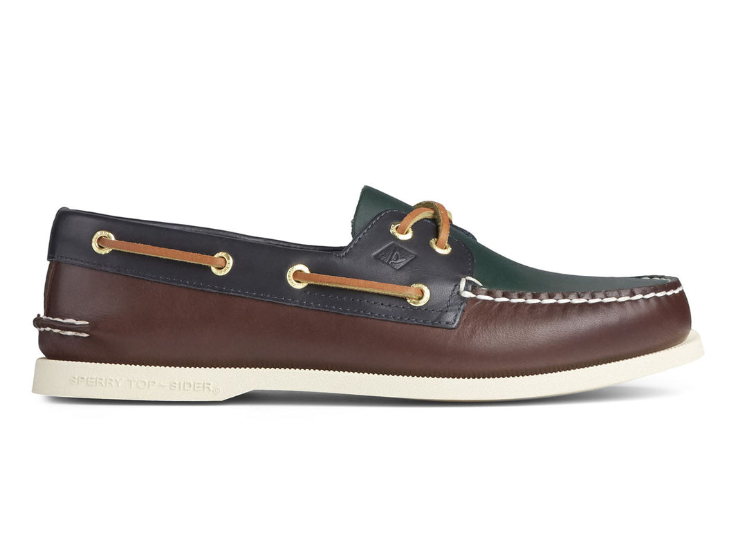 Zapato náutico Sperry multicolor en cuero verde, marrón y azul marino con suela blanca.