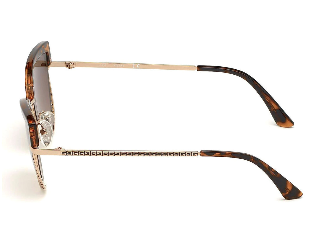 Lentes de sol Guess para mujer con armazón en color carey y detalles metálicos dorados en forma de cat-eye.