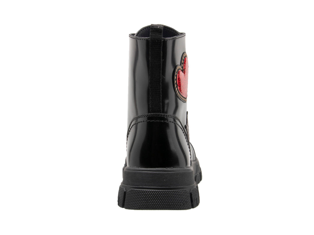 Bota negra brillante con decoraciones de corazón rojo y estrella plateada y suela track.