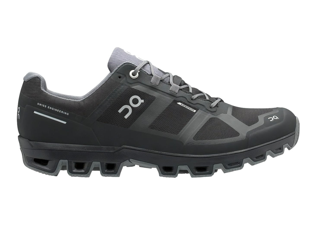 Tenis deportivos On Cloud Cloudventure color negro y gris oscuro con suela para terreno irregular.