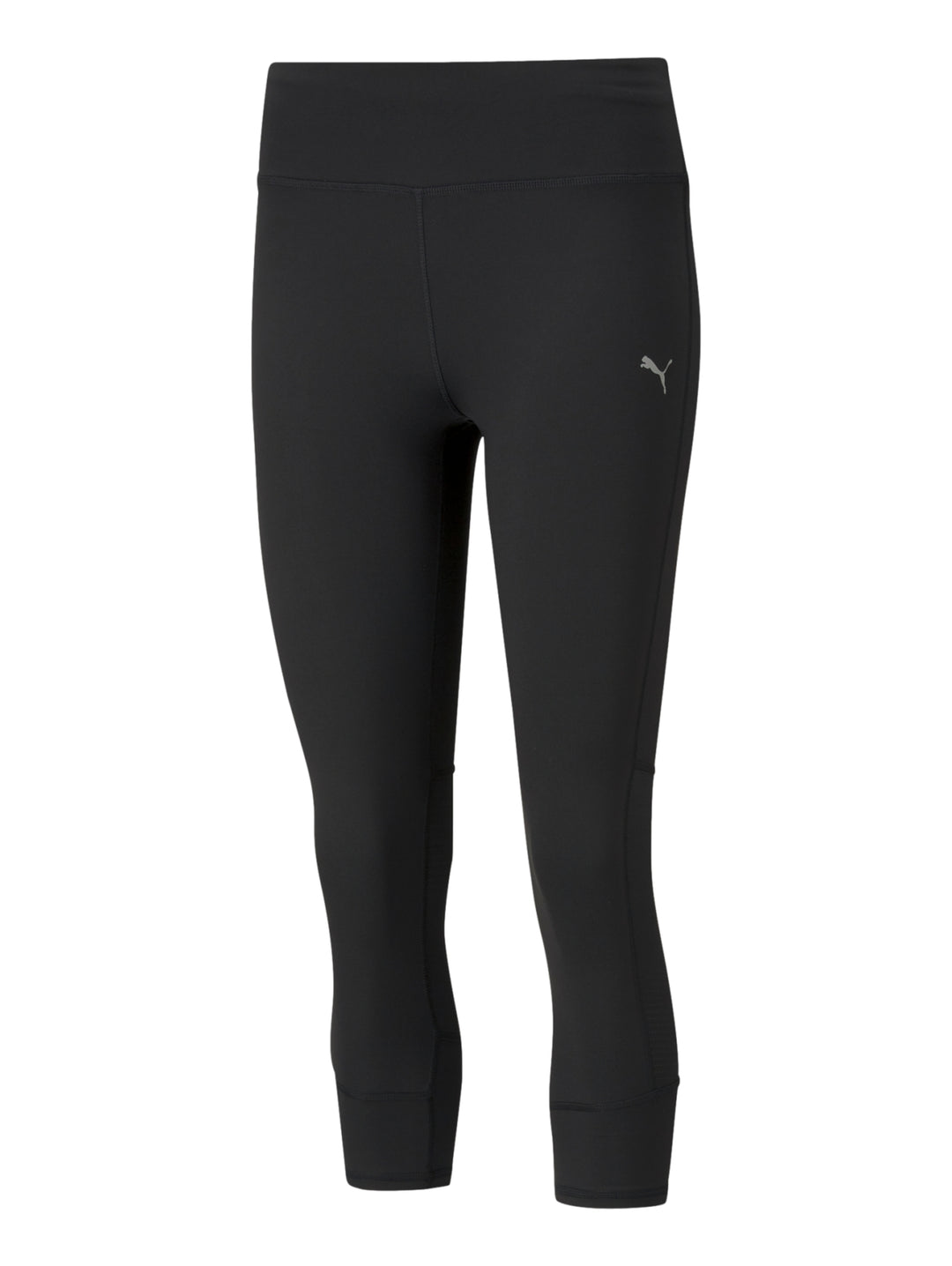 Mujer vistiendo mallas deportivas PUMA de color negro, longitud 3/4, ajustadas al cuerpo.