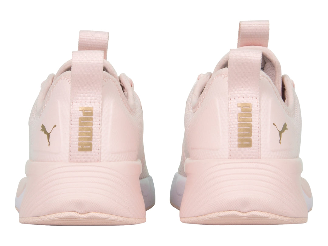 Zapatilla deportiva PUMA en color rosa claro con suela blanca y detalles de malla transpirable.