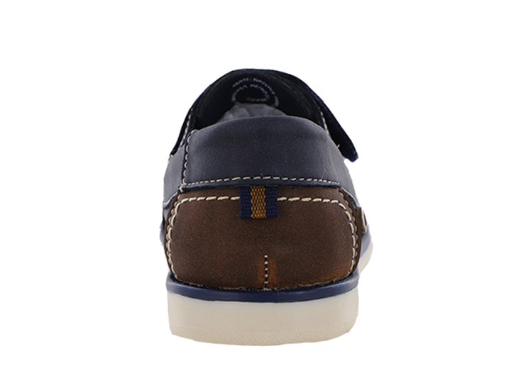 Zapatos tipo mocasín color azul marino para niño con suela blanca y detalles en café.