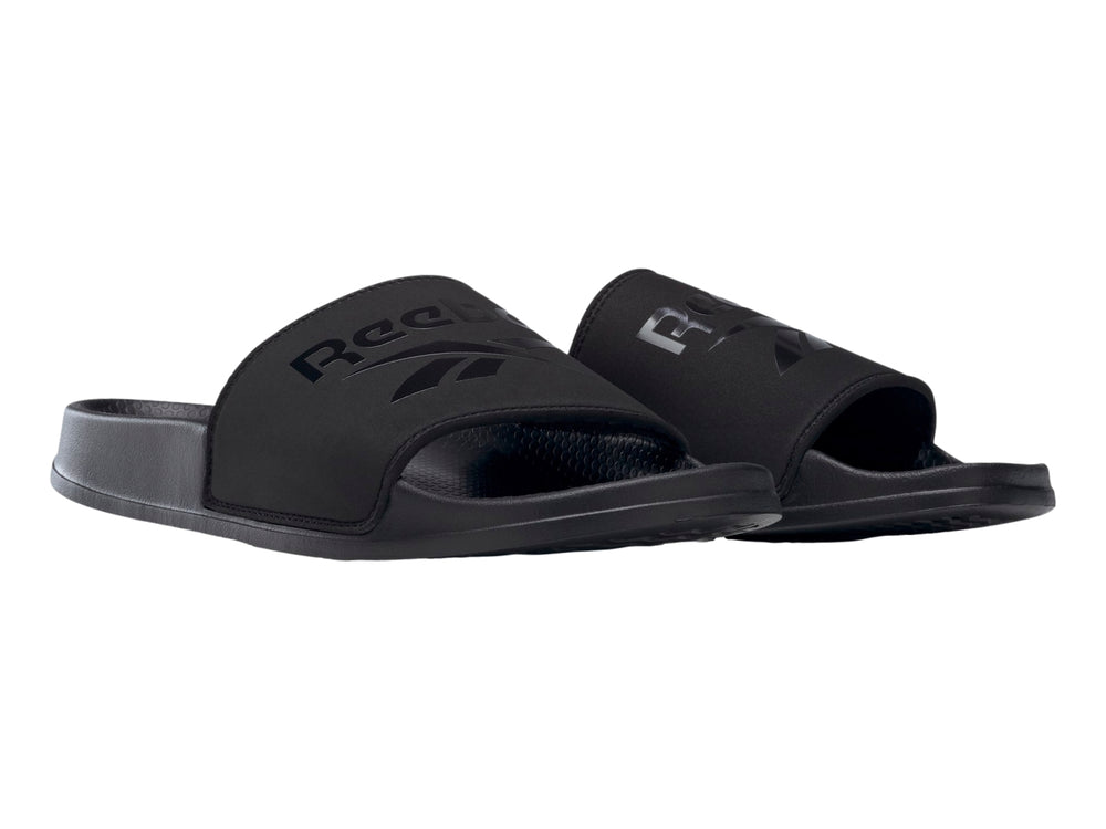 Sandalia deslizable Reebok modelo Fulgure Slide en color negro sólido con logotipo en la banda superior.