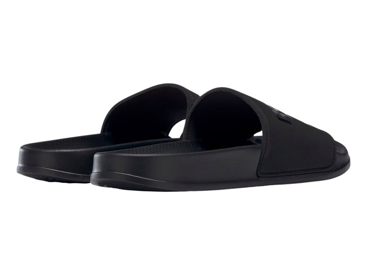 Sandalia deslizable Reebok modelo Fulgure Slide en color negro sólido con logotipo en la banda superior.
