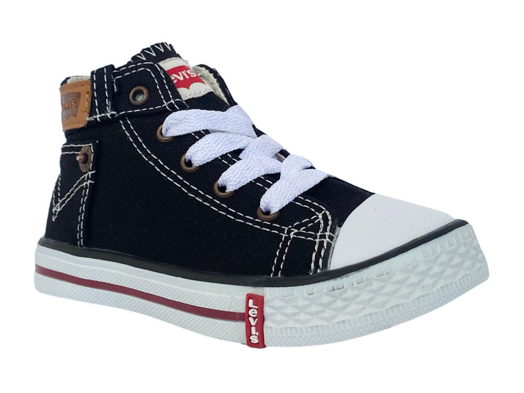 Tenis infantiles de lona color negro con punta y suela blanca.