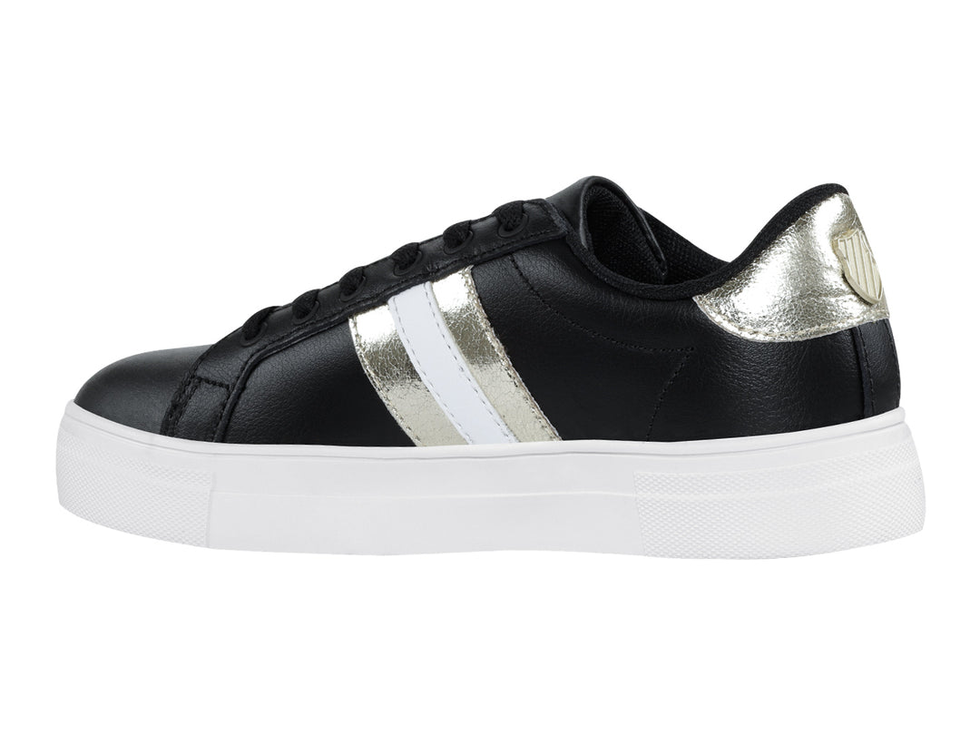 Tenis K-Swiss Radiance para mujer en color negro con franjas doradas y suela blanca.