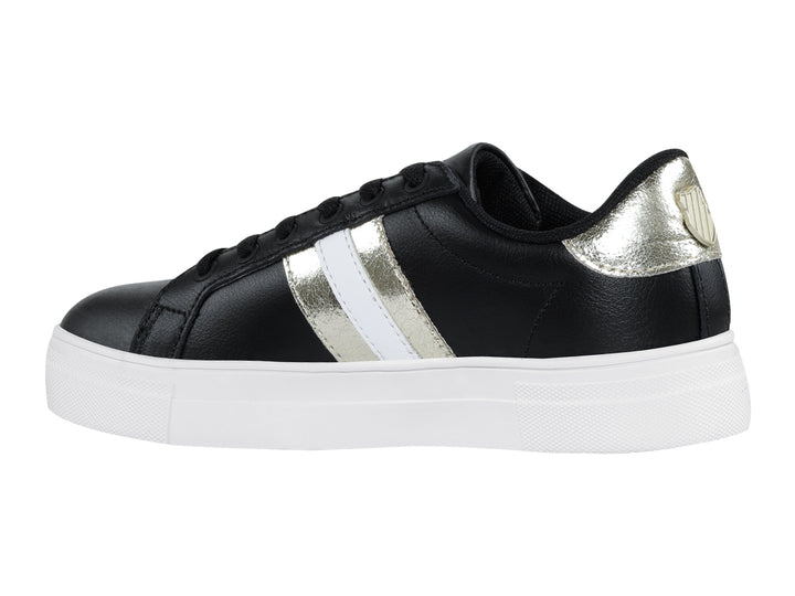 Tenis K-Swiss Radiance para mujer en color negro con franjas doradas y suela blanca.