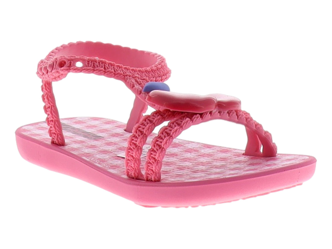 Sandalia Ipanema color rosa con correas de textura tejida y detalle azul en la parte superior.