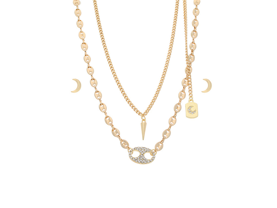 Set de collares en capas color oro con dijes de luna, punta y óvalo con cristales.