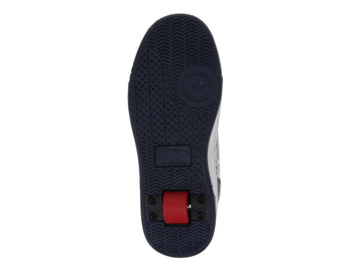 Tenis Heelys color azul marino con detalles en blanco y rojo, diseño gráfico lateral y suela blanca gruesa.