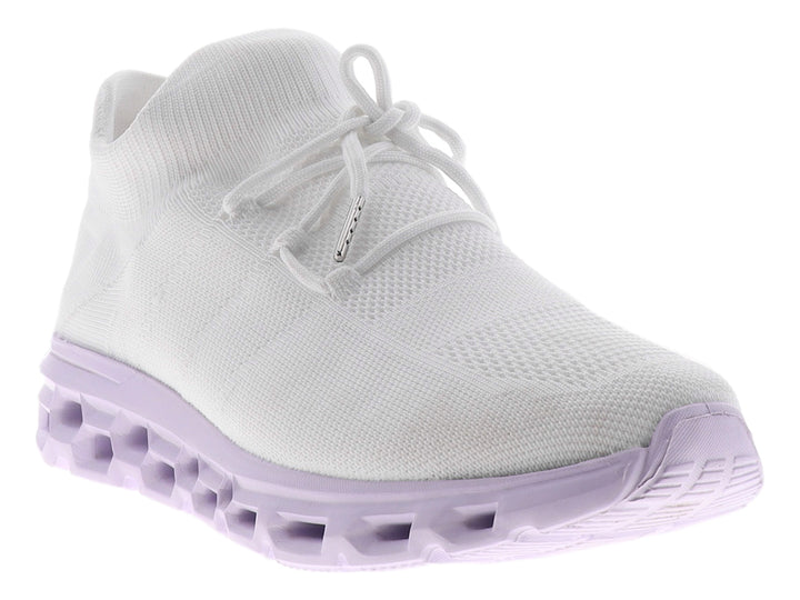 Tenis blancos de tela con suela gruesa color morado claro y diseño perforado.