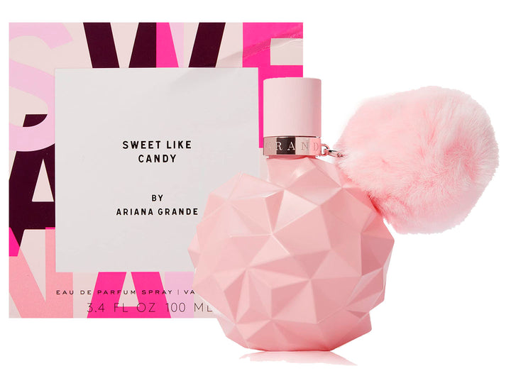 Perfume Ariana Grande Sweet Like Candy en botella rosa facetada con un pompon rosa y su caja blanca y rosa.