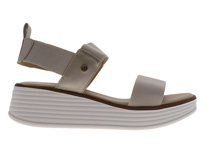 Sandalia de plataforma color beige con tiras elásticas y suela blanca gruesa.