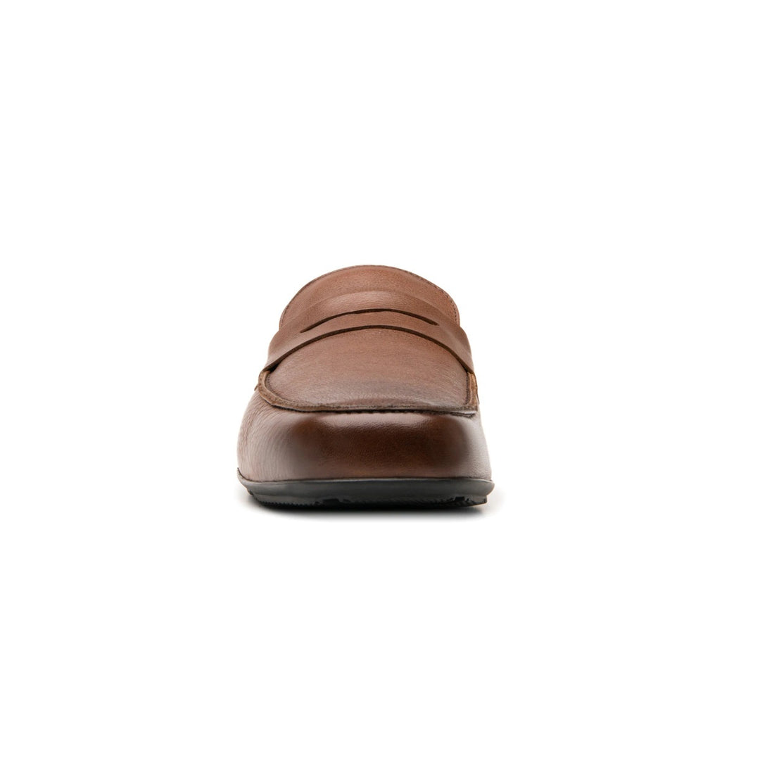 Zapato tipo mocasín color café con suela negra.