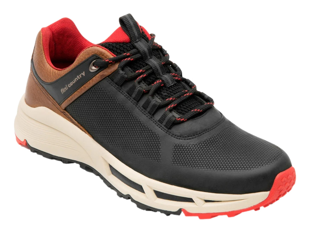 Zapato deportivo Flexi negro con detalles en café, suela blanca y acentos rojos.