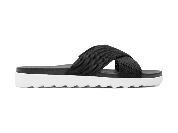 Sandalias Flexi negras de textil con correas cruzadas y suela blanca contrastante.