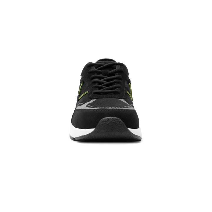 Tenis deportivos Flexi color negro con detalles en verde lima y suela blanca.