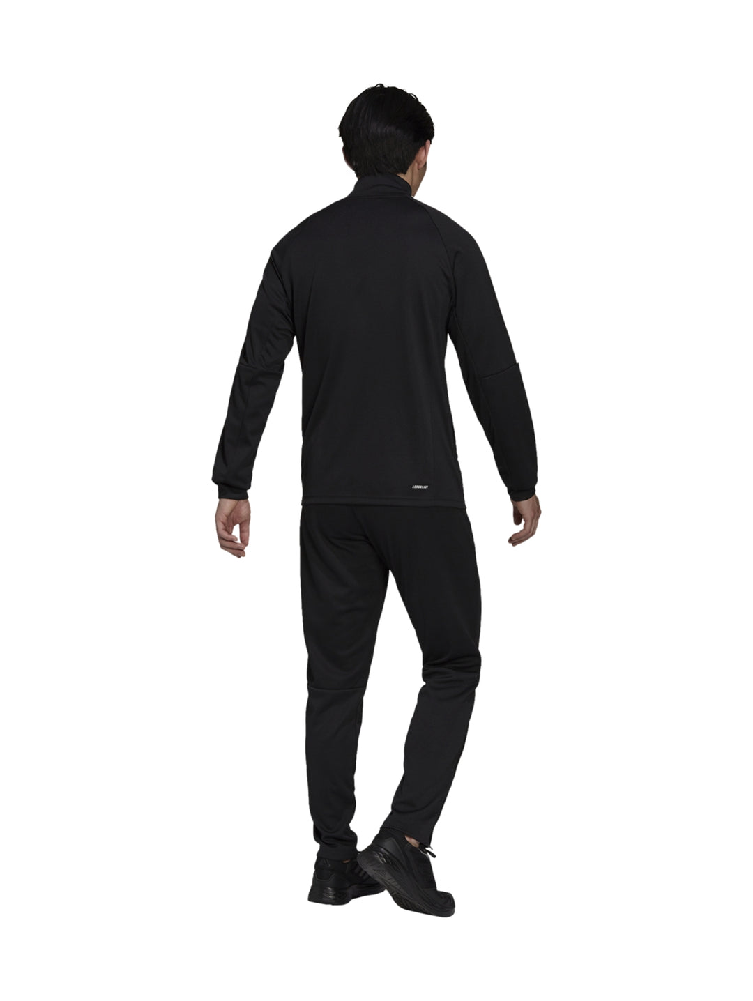 Hombre vistiendo conjunto deportivo Adidas de color negro con rayas blancas en las mangas.