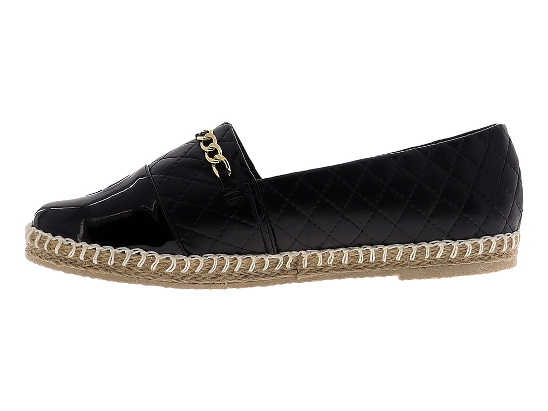 Alpargata negra para mujer con diseño acolchado, cadena dorada y suela de fibras naturales.