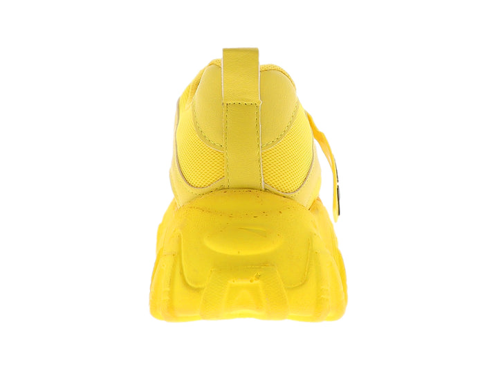 Tenis deportivos color amarillo con suela chunky y agujetas con detalles en blanco y negro.