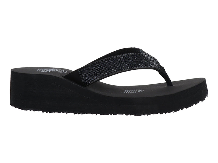 Sandalias negras de plataforma con tira brillante tipo flip-flop.