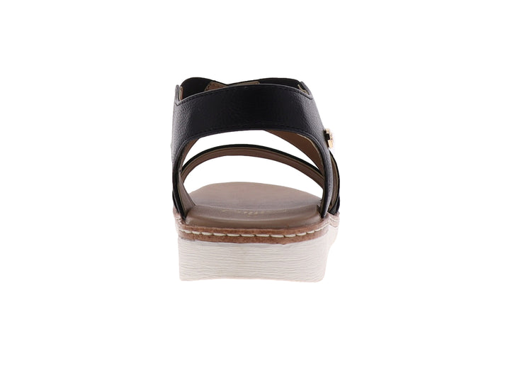 Sandalia casual para mujer de color negro con tiras cruzadas y suela blanca.