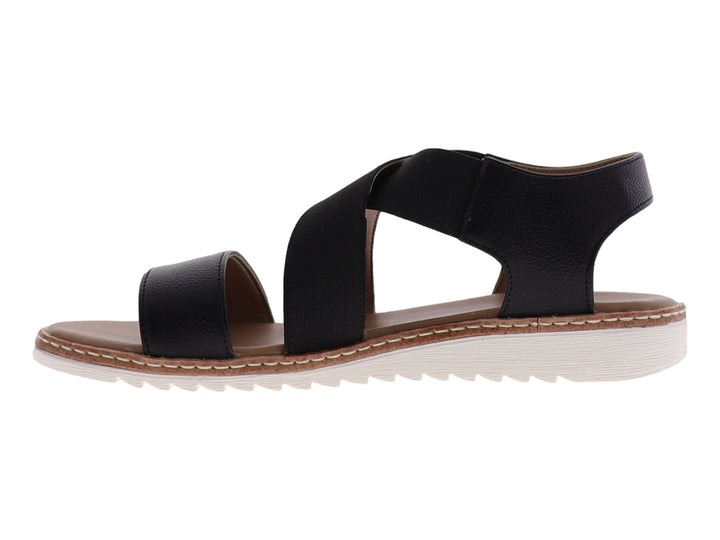 Sandalia casual para mujer de color negro con tiras cruzadas y suela blanca.